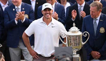 Brooks Koepka poses next to the PGA Championship trophy