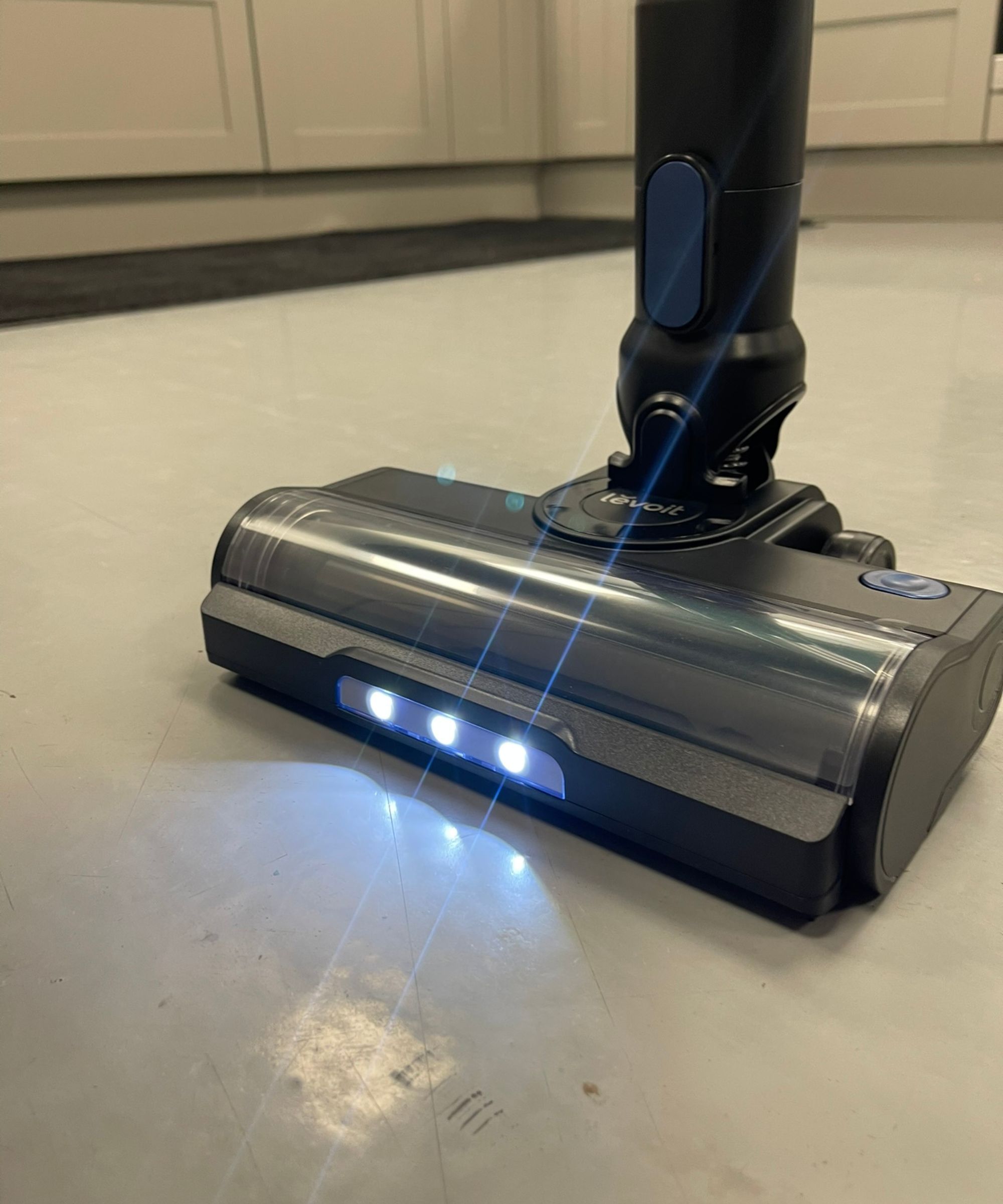 Levoit LVAC-300 cordless vacuum cleaner floorhead, with LED lights illuminating the linoleum floor in Future test center.