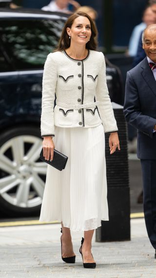 Kate Middleton in a white skirt and cream boucle jacket