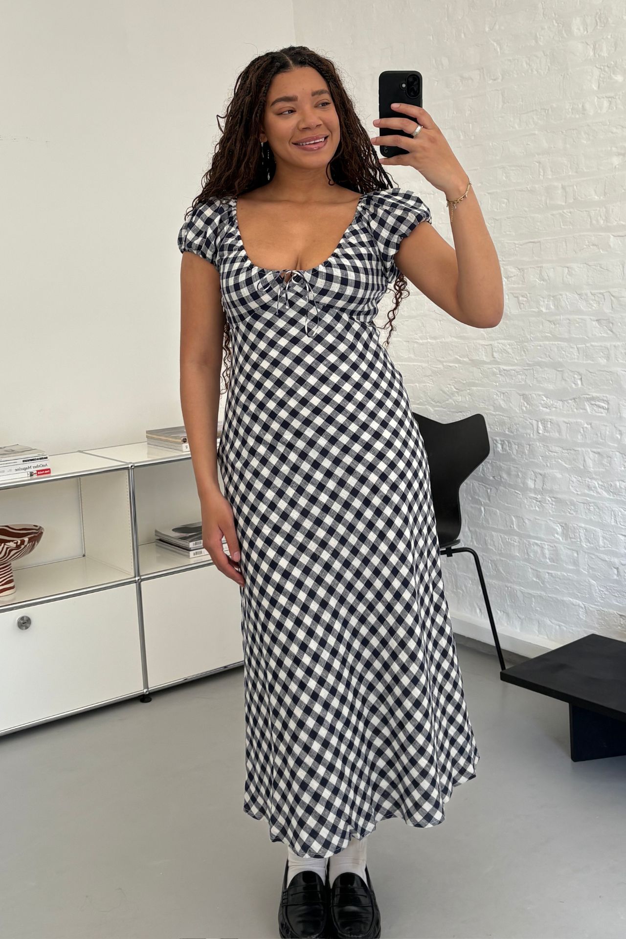 Fashion editor Imani wears the Gap x DÔEN Linen Gingham Maxi Dress with black loafers.