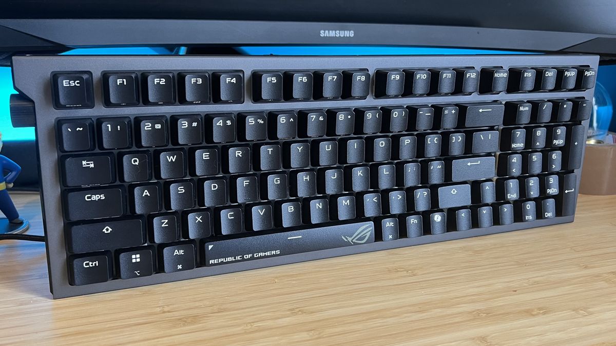 Asus ROG Strix Morph 96 Wireless gaming keyboard standing upright on a wooden desk