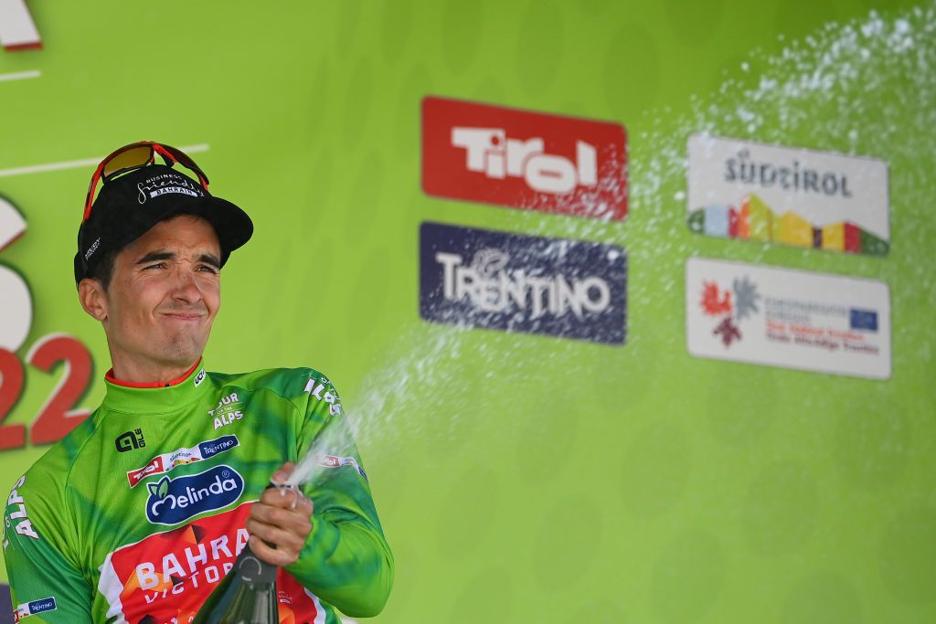 TOBLACH HOCHPUSTERTAL ITALY APRIL 20 Pello Bilbao Lpez De Armentia of Spain and Team Bahrain Victorious celebrates winning the green leader jersey on the podium ceremony after the 45th Tour of the Alps 2022 Stage 3 a 1546km stage from Lana to Villabassa TouroftheAlps on April 20 2022 in Toblach Hochpustertal Italy Photo by Tim de WaeleGetty Images