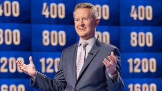 Ken Jennings smiling with clue board in the background on Jeopardy! Masters