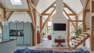 Living and kitchen area with wooden beams