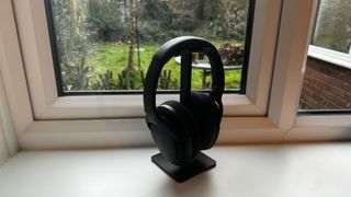 Titum headphones on a stand on a window sill