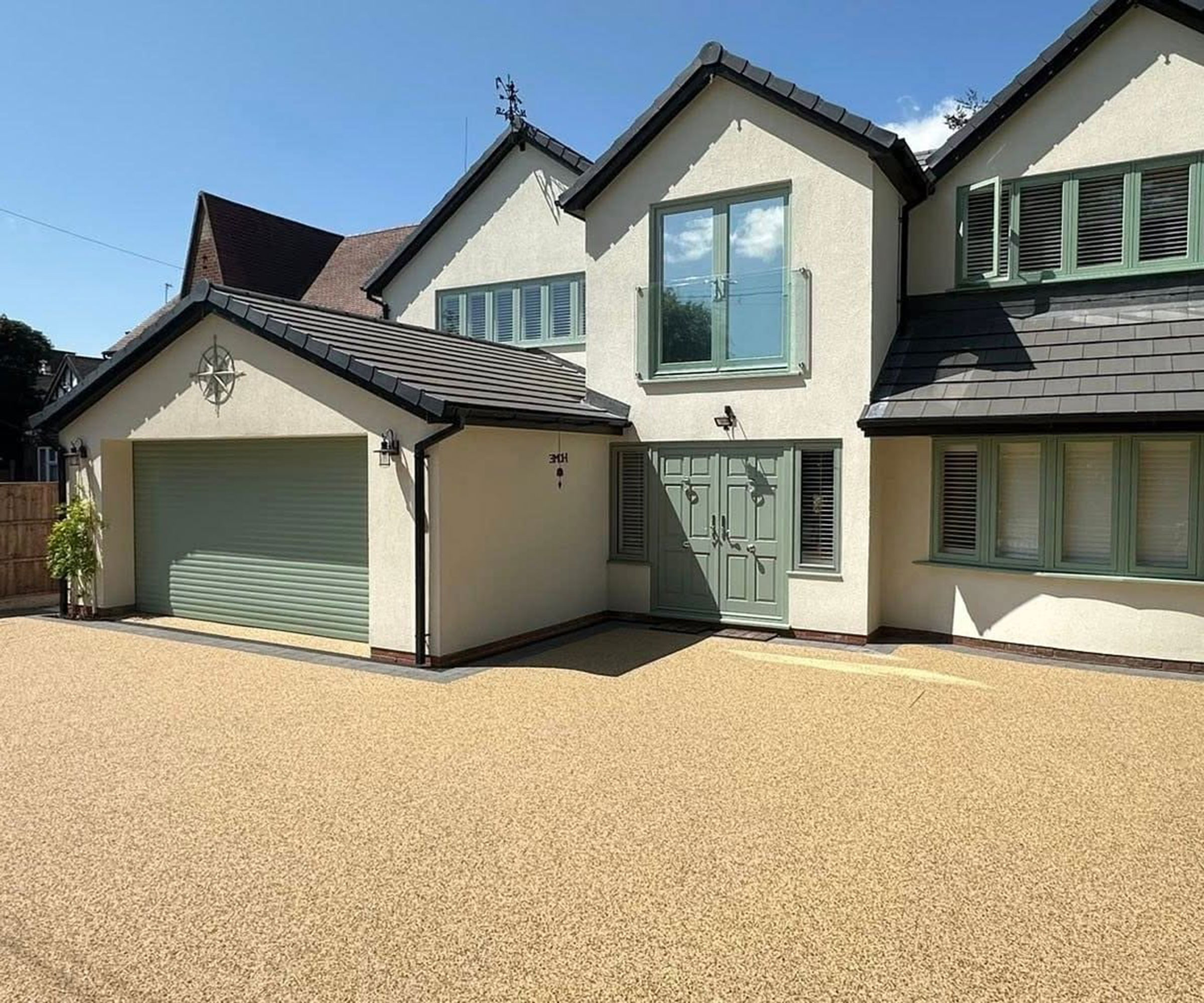 Modern rendered house with gravel grid driveway