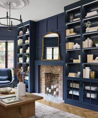 Blue living room with floor to ceiling decorated shelving