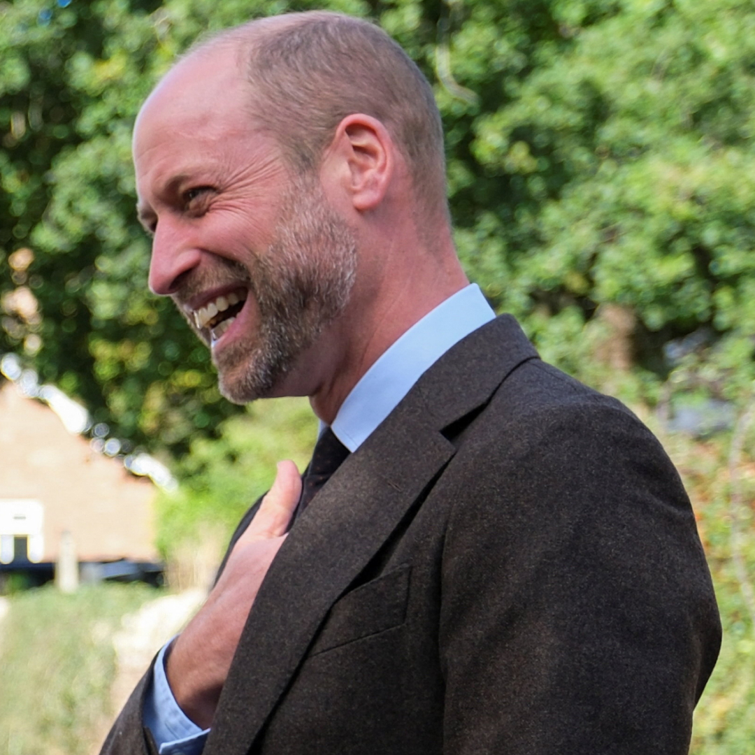 Prince William laughing while talking to a couple in Wales