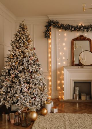 A living room with a Christmas tree and hanging tree lights