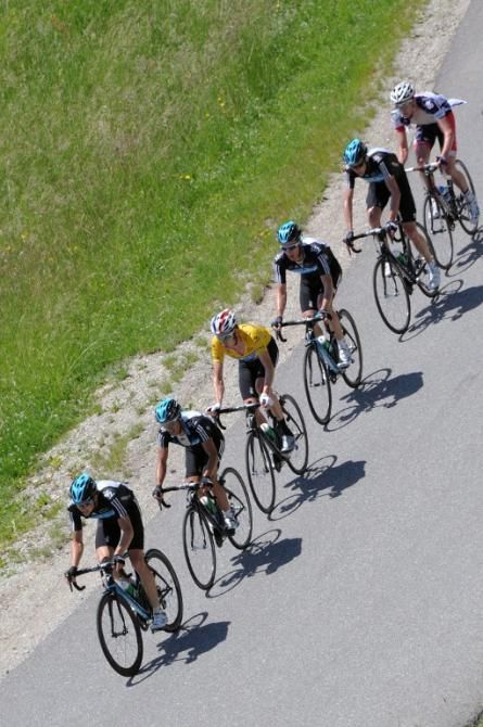 Yellow jersey leader Bradley Wiggins (Sky) in a familiar position, flanked by his teammates at the Dauphin&eacute;
