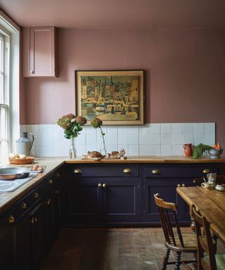 kitchen with black cabinets and pink walls