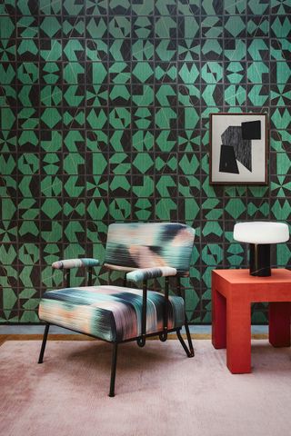 A living room with a dark green wallpaper