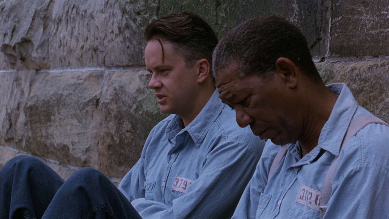 Morgan Freeman and Tim Robbins sitting together in The Shawshank Redemption