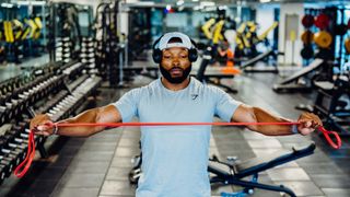 Obi Vincent warming up with a resistance band for a kettlebell workout