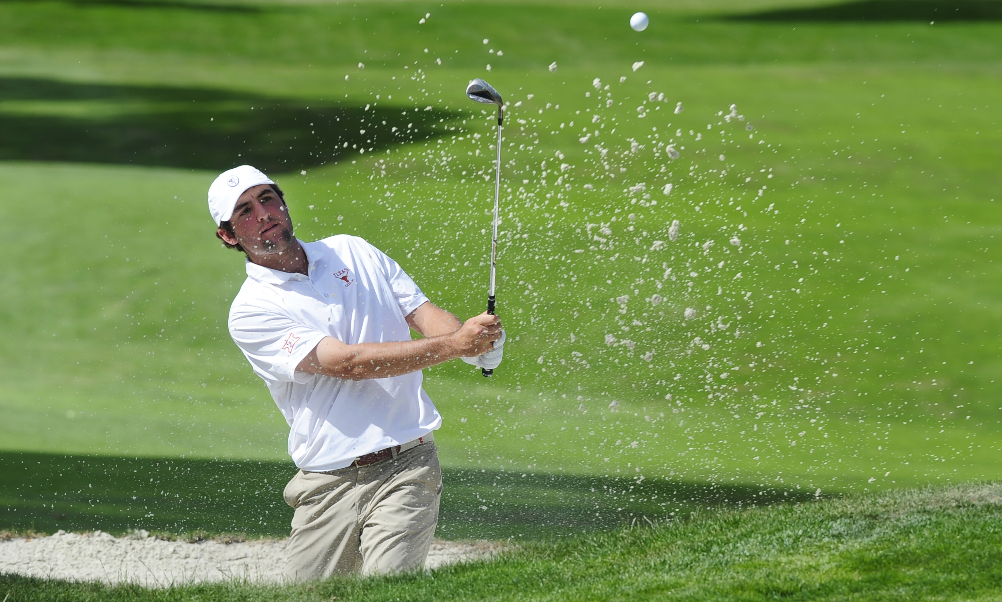 Scottie Scheffler hits a bunker shot