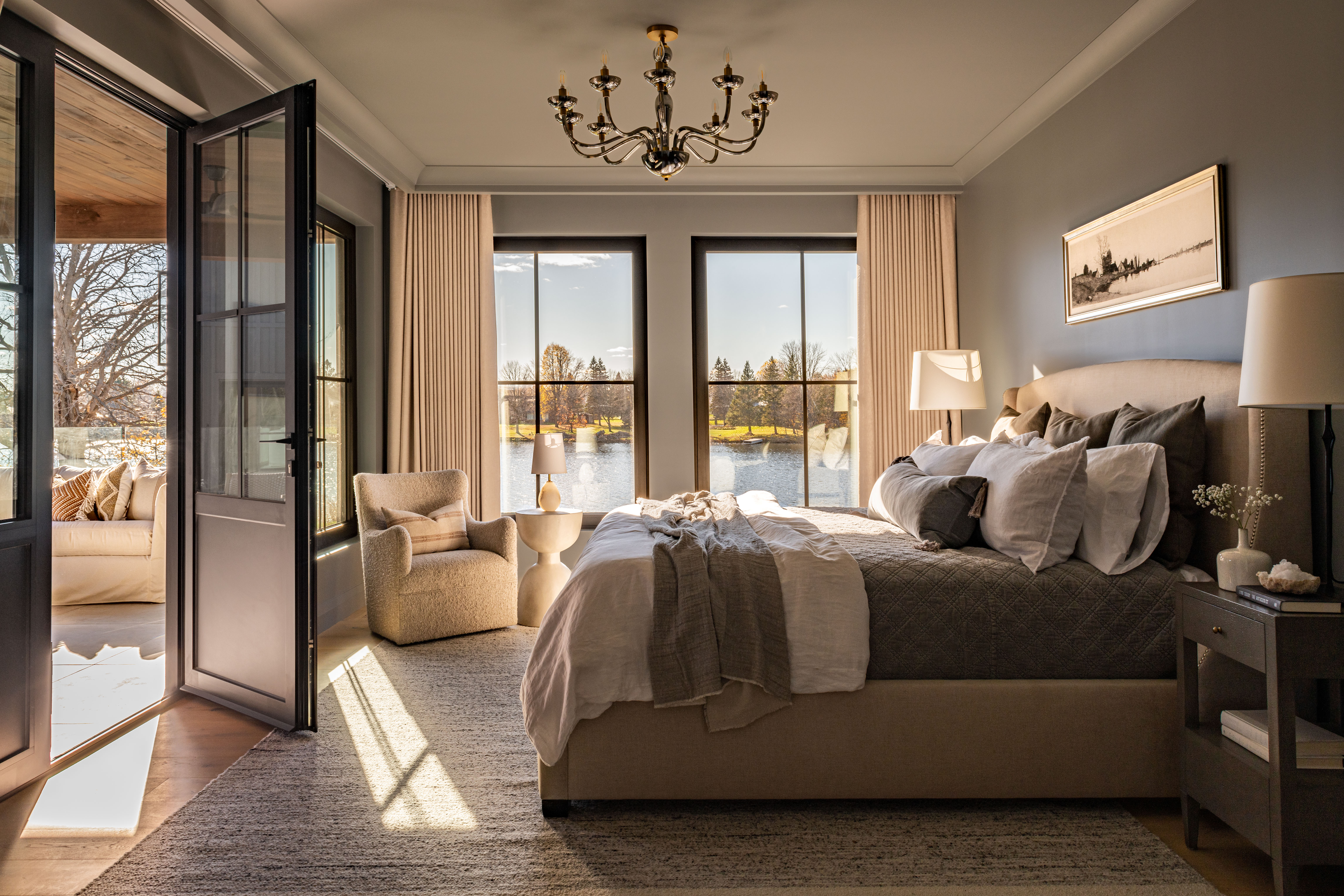 A riverside bedroom in neutral tones filled with natural light.