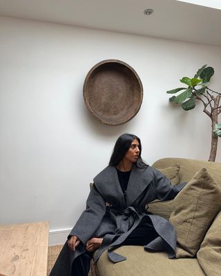 Monikh wears belted coat