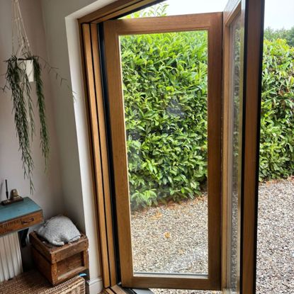 Natasha's composite bifold doors with warm oak internal frame and light grey powder coated aluminium outer frame