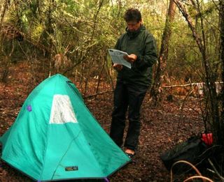 North Florida, many more miles to go: Davis consults his map at his campsite.