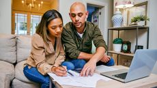 A couple work on financial planning together at home.