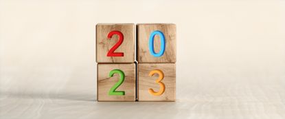 2023 text on wooden toy blocks stacked as a square
