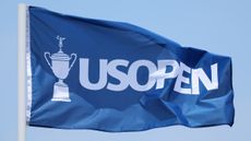 A large blue US Open flag blows in the wind