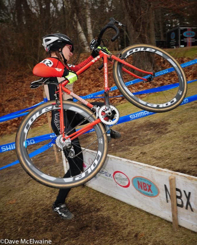 Britlee Bowmann (House Industries) lifting Richard Sachs bike over the barriers