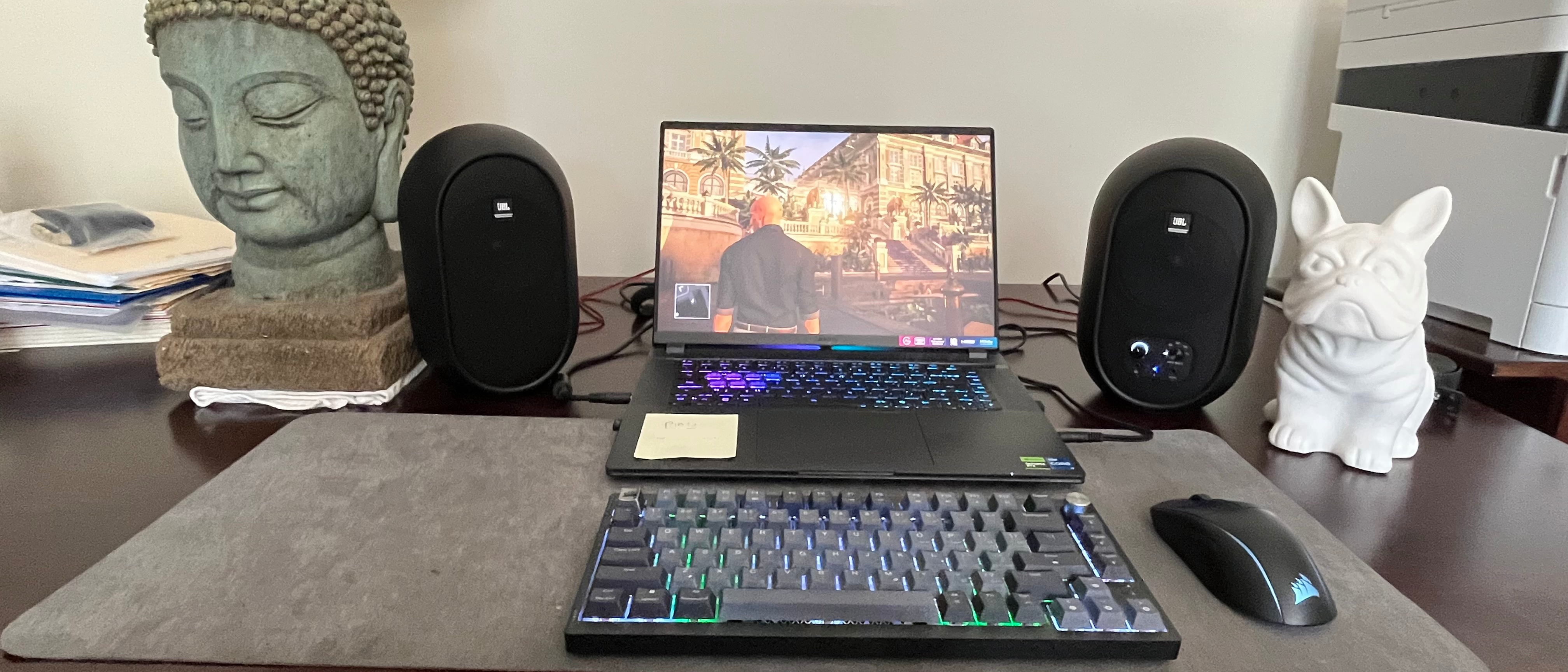 JBL 104-BT speakers set up on either side of a gaming laptop