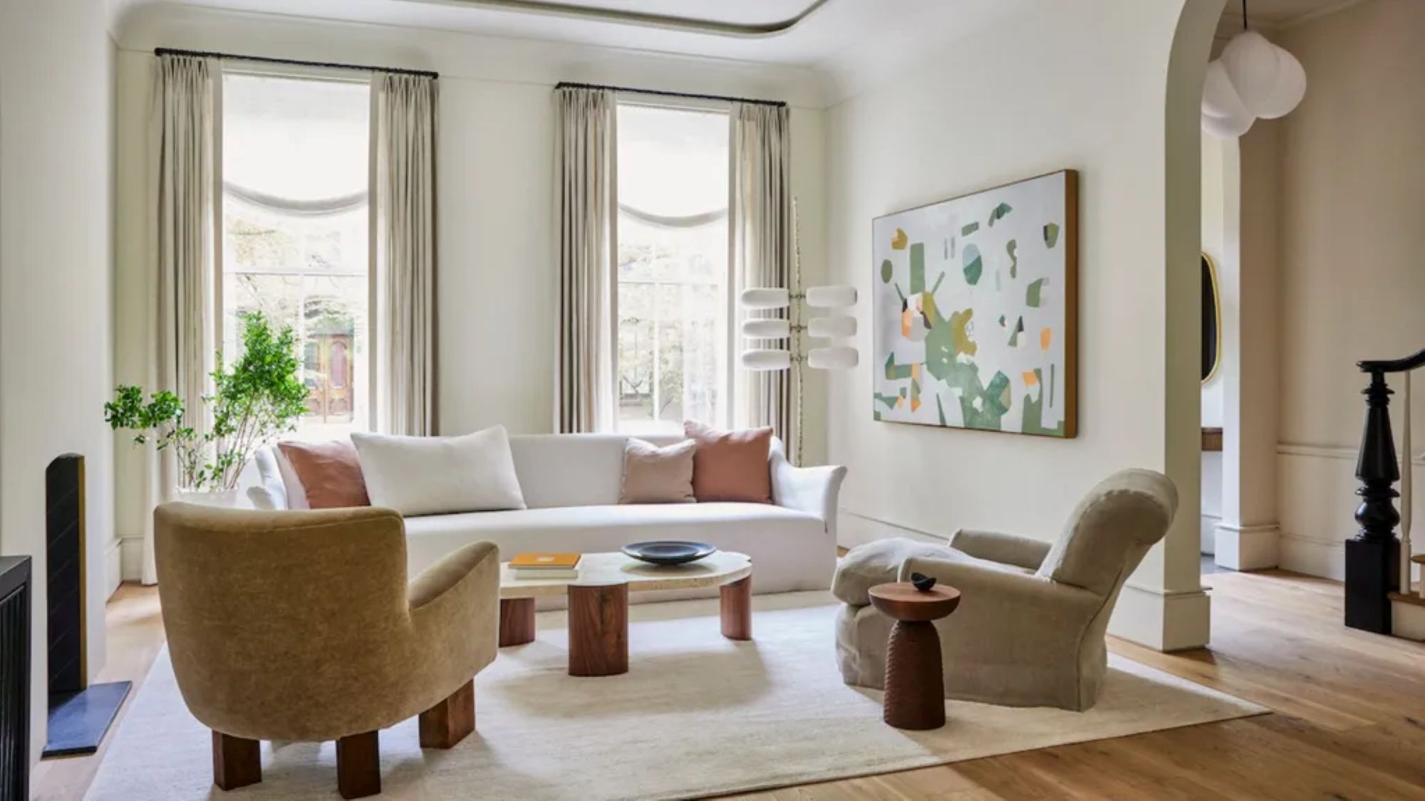 A clean home with accent chairs and a white sofa