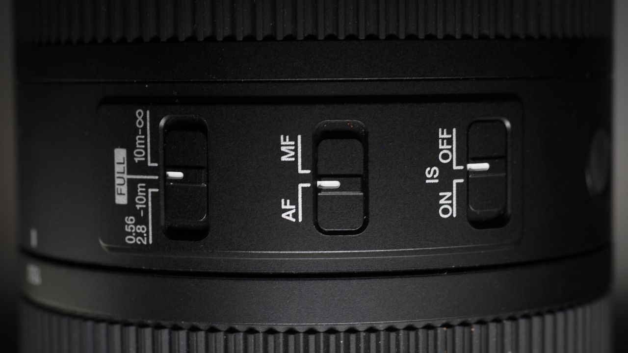 OM System M.Zuiko 150-600mm f/5.0-6.3 IS lens, mounted to an OM System OM-1 Mark II, on a wooden surface lit with moody lighting