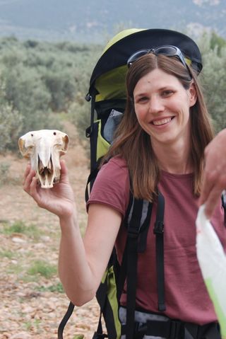 Natalie Munro with the skull of a domestic goat in the Peloponnese, Greece.