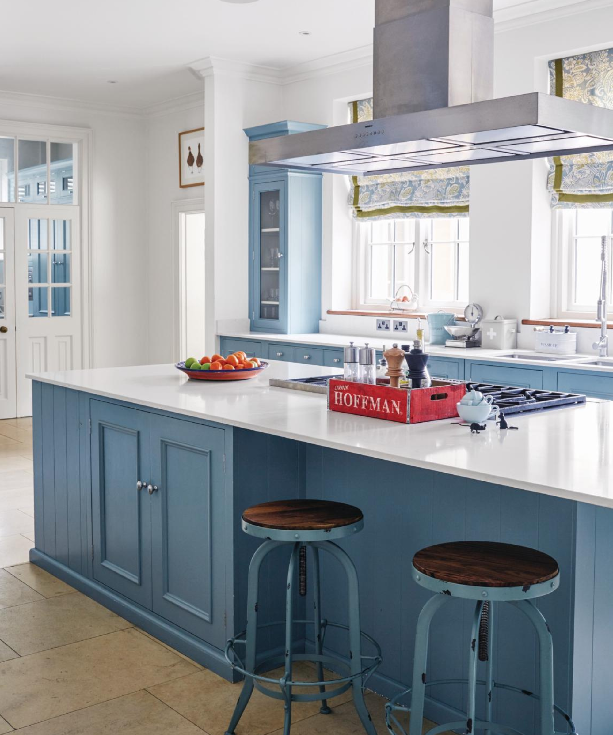 a kitchen with blue cabinetry and a white countertop