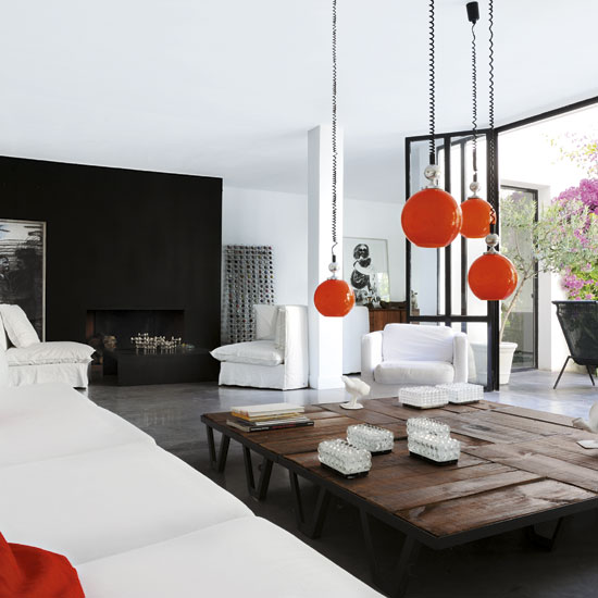 living room with wooden table and white ceiling with ceiling lamps