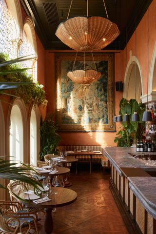 The history-drenched interiors of Belvedere, with wall tapestries and pendant rattan chandeliers.