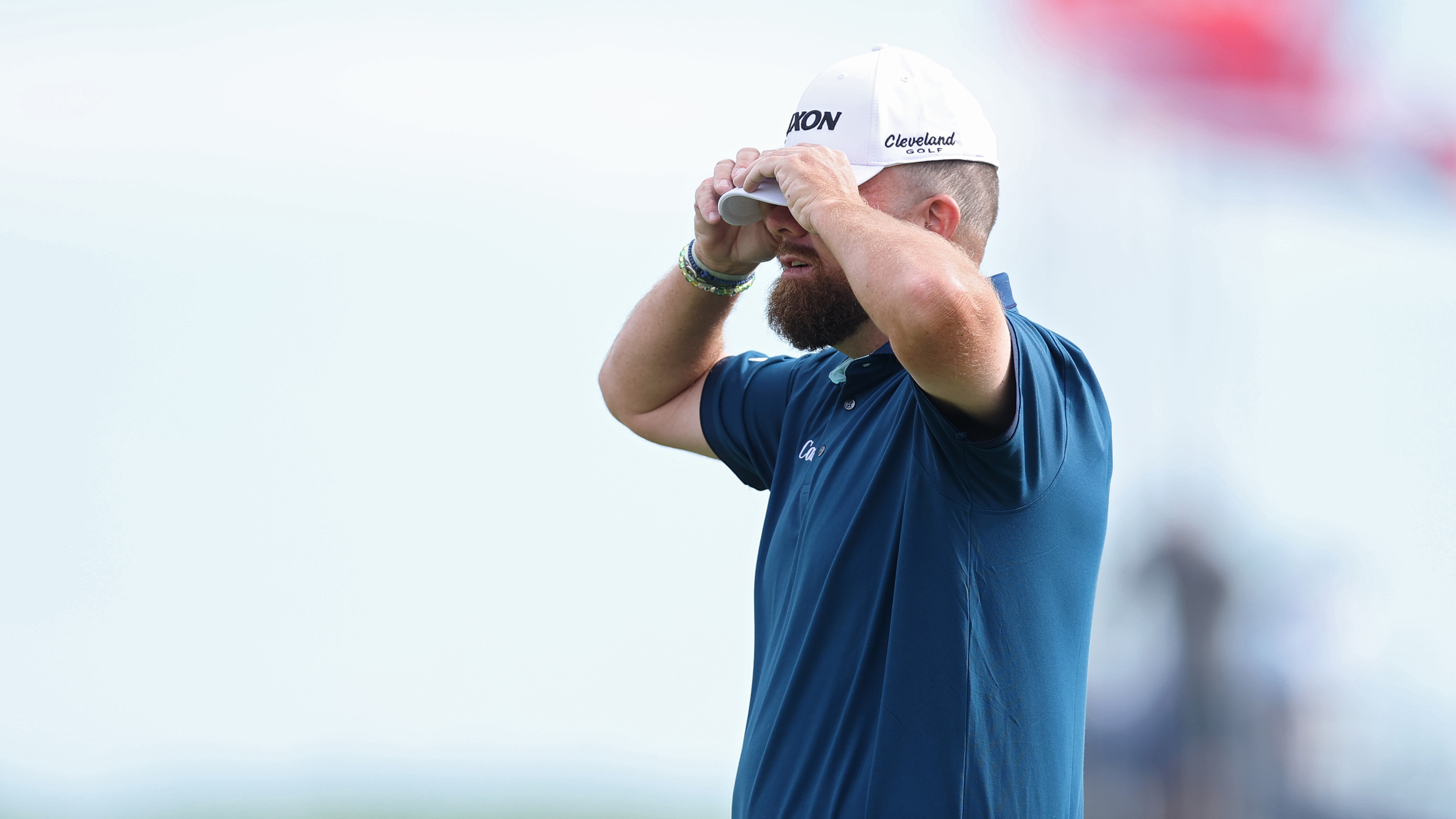 Shane Lowry covers his eyes with his cap in disappointment at the US Open