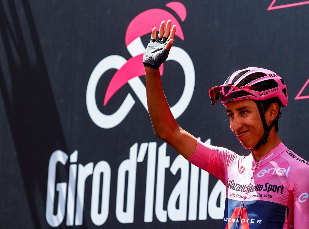 Team Ineos rider Colombias Egan Bernal wearing the overall leaders pink jersey waves prior to the start of the 13th stage of the Giro dItalia 2021 cycling race 198km between Ravenna and Verona on May 21 2021 Photo by Luca Bettini AFP Photo by LUCA BETTINIAFP via Getty Images