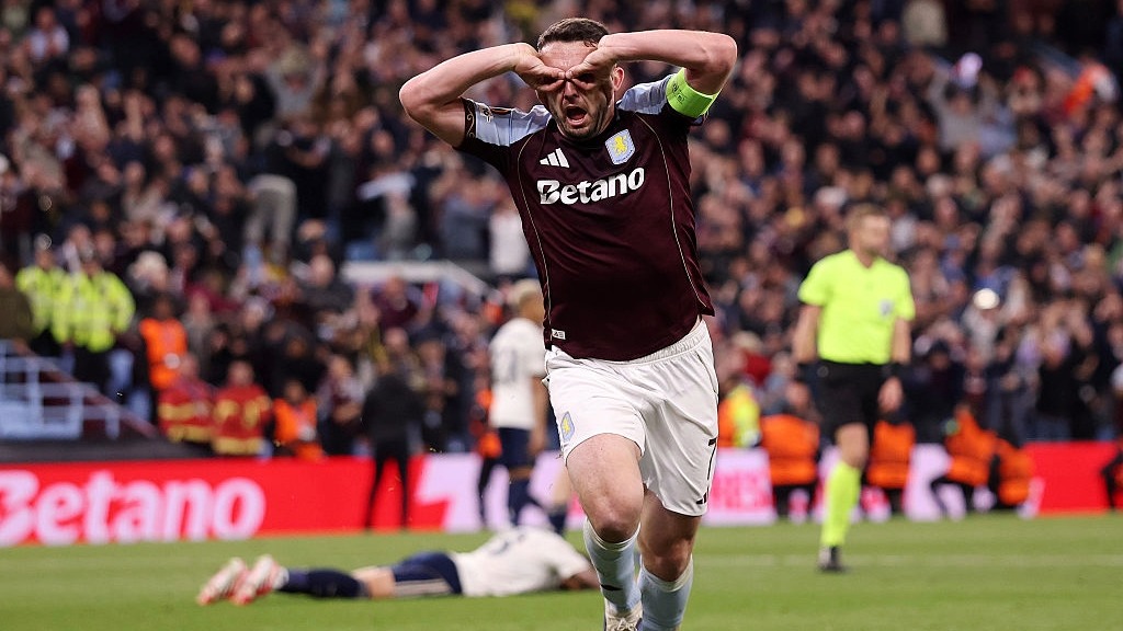 John McGinn makes some spectacles with his fingers to celebrate Aston Villa reaching the Europa League final