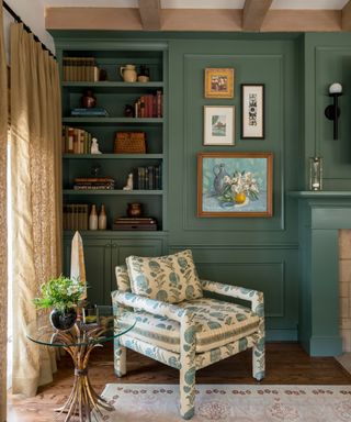 A gray-green living room with an armchair and artwork