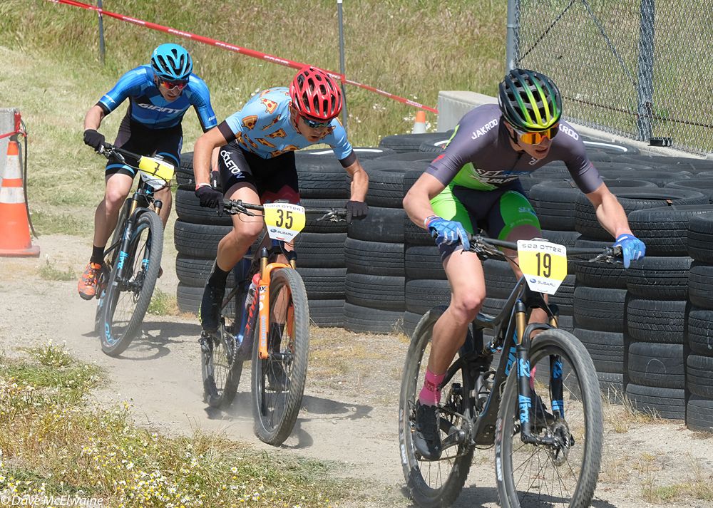 Alec Pasqualina riding mid-pack and dodging some of the tires on the course