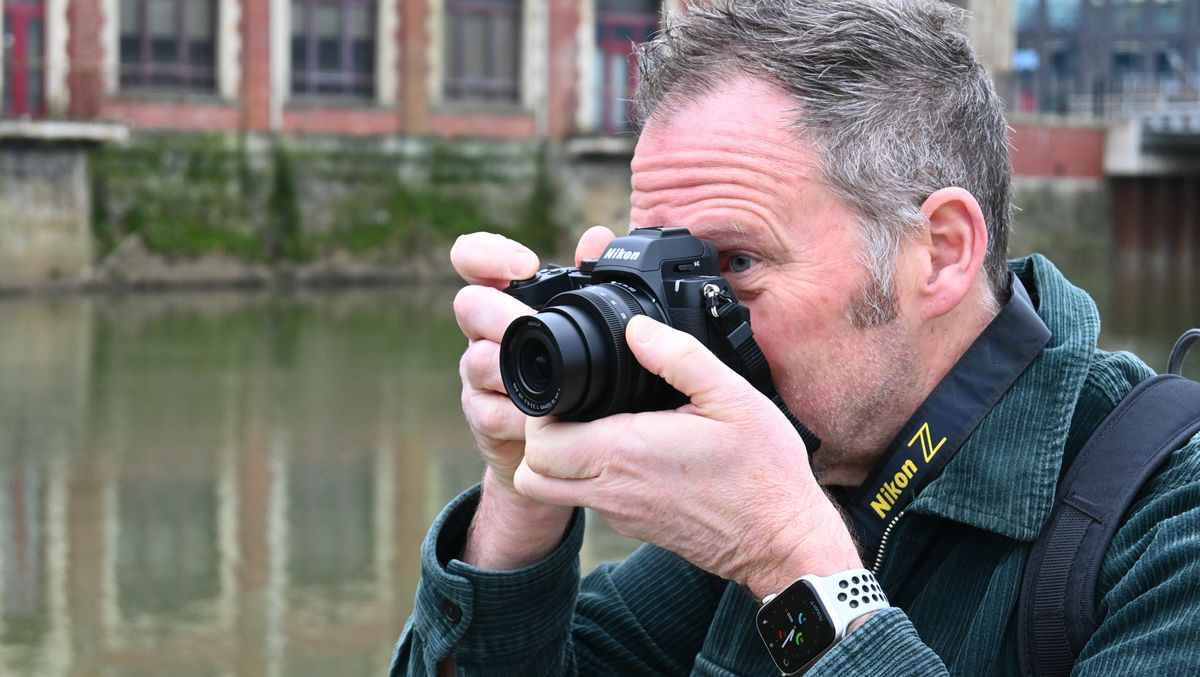 Man looking through Nikon Z50 II viewfinder