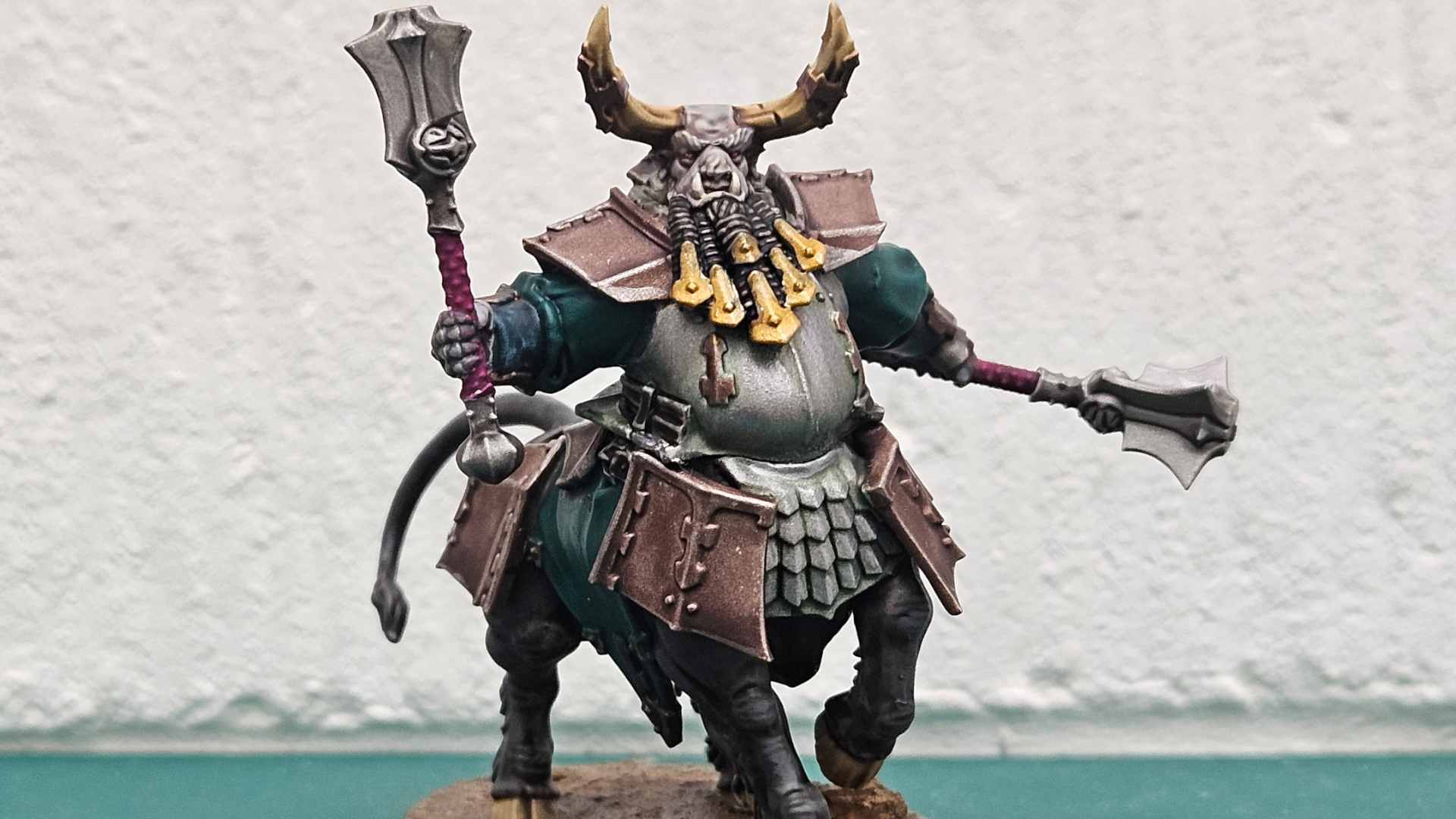 Painted Bull Centaur with twin maces against a plain white wall