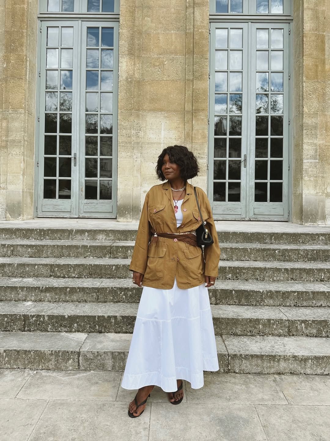 Franny in a scarf belt and white skirt