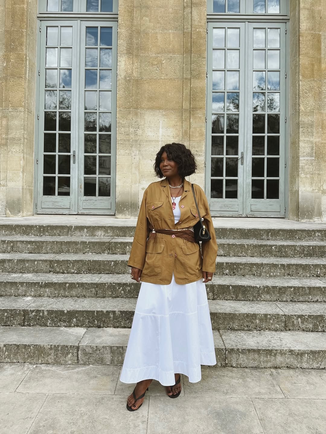 Franny in a scarf belt and white skirt