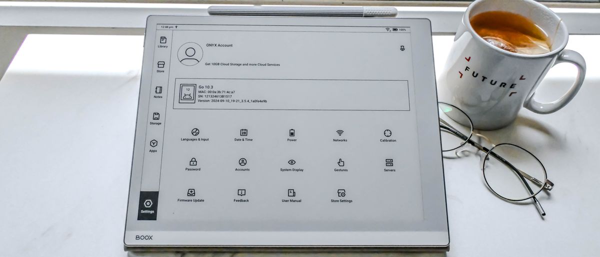 The Onyx Boox Go 10.3 e-paper writing tablet with stylus on a tablet with a cup of tea and glasses