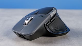 A photo of the Logitech MX Master 4 on a stone surface with a blue background
