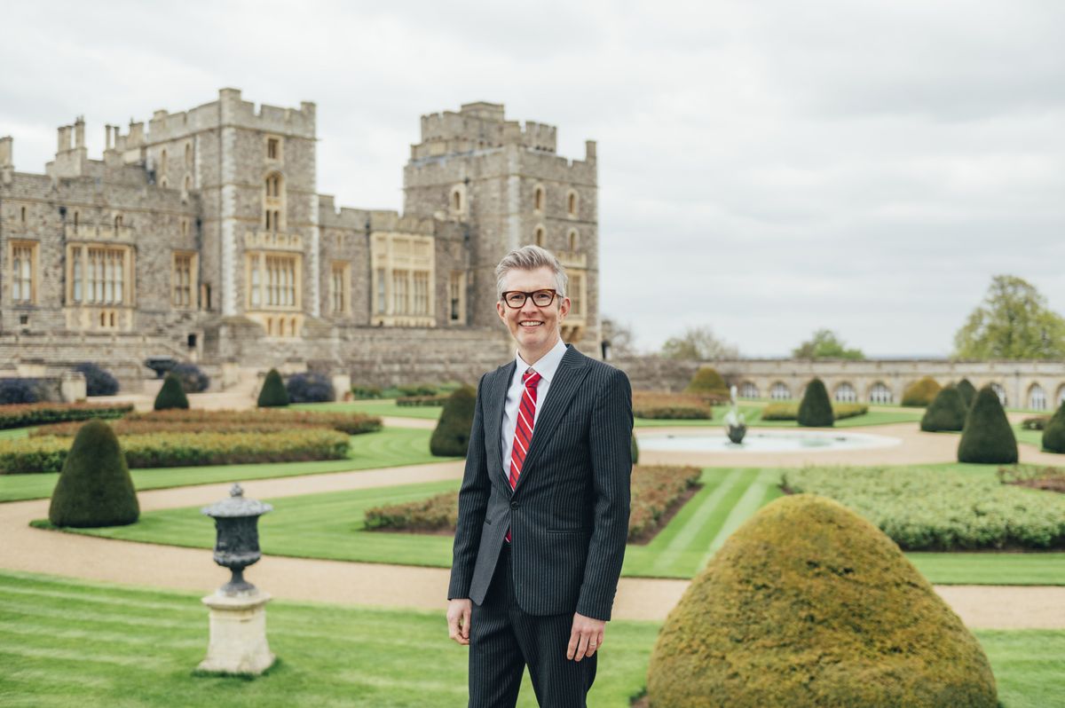 Sing For The King: The Search for the Coronation Choir&#039;s Gareth Malone wearing a suit in front of Windsor Castle