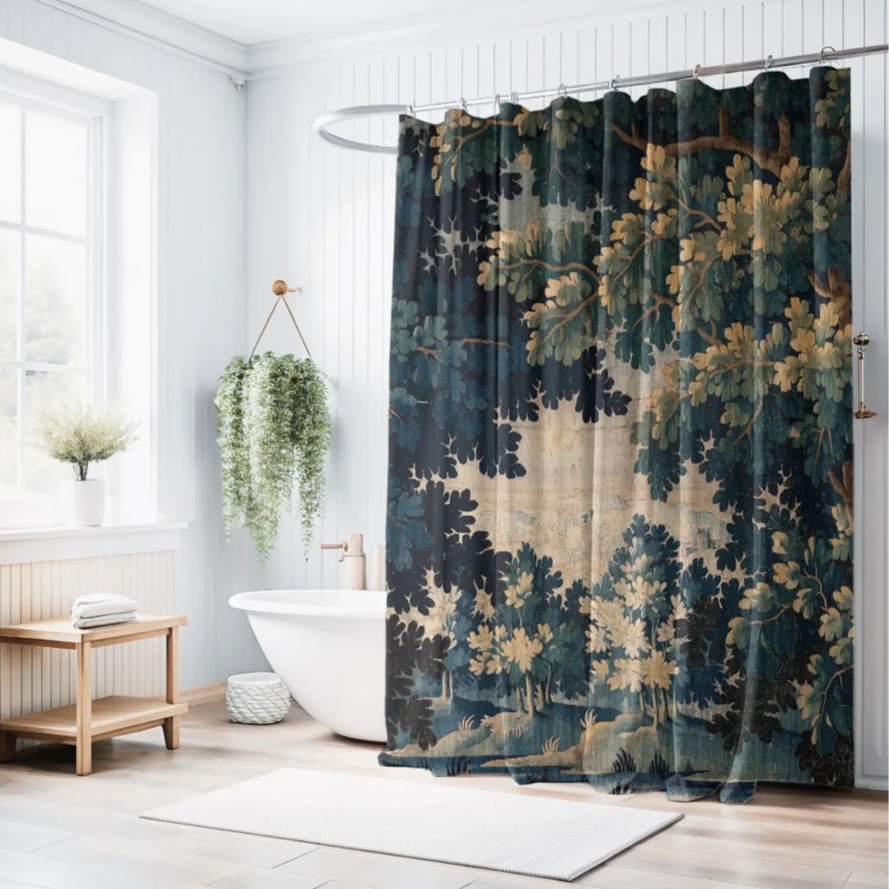 A bright bathroom with a freestanding bath and a patterned shower curtain, featuring leafy motifs in deep green tones that add colour and character to the space.