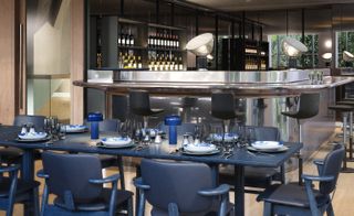 The bar is lined with stools designed by Barber & Osgerby for Vitra of Parabola — London, UK