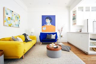white living room with yellow sofa by Banner Day Interiors