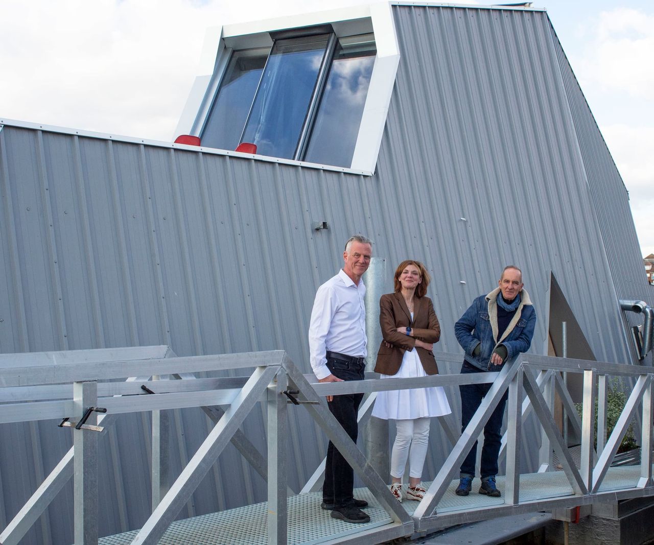 Kevin Mccloud with a couple on a stairway